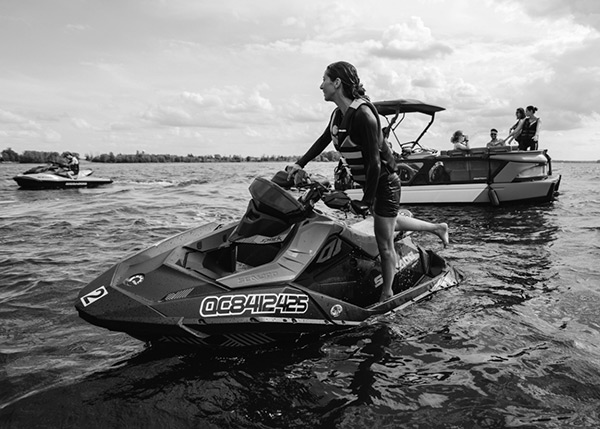 Woman on a personal watercraft on a body of water, representing the powersports marine sector served by BRP Spruce Pine