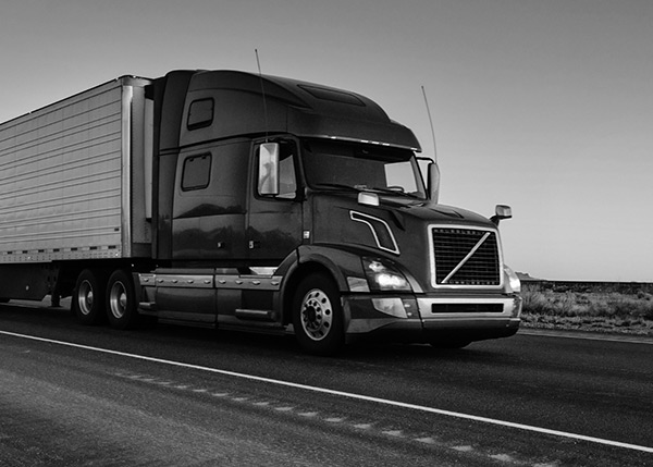 Transport truck on the highway, representing the logistics sector served by BRP Spruce Pine